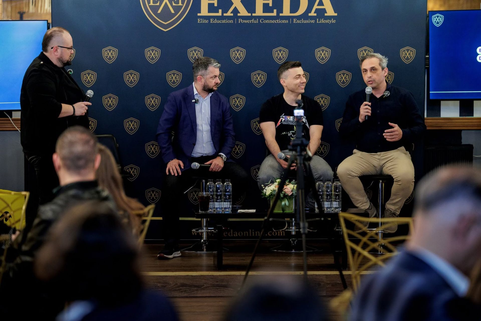 Costin Teodorovici, at right, speaking during the AI panel at EXEDA Continuum